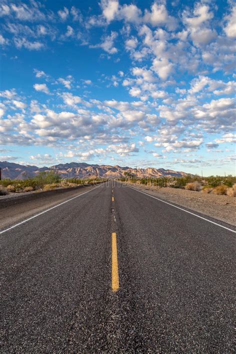 Long Straight Road Through A California Desert Stock Photo