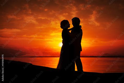 Silhouette Of Couple Kissing In Sunset Stock Photo Adobe Stock