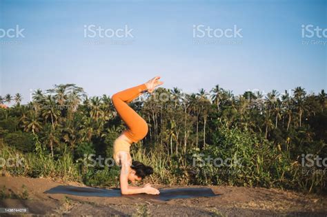 Strong Caucasian Female In Active Wear Standing In Inverse Asana On