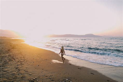 Little Naked Girl Running Along The Beach At Sunset By Stocksy Contributor Evgenij Yulkin