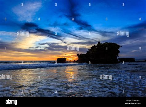 Silhouette Of Tahah Lot Temple And Ocean Waves At Sunset Bali