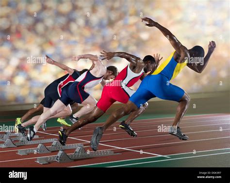 Four Athletes Starting A Sprint Race Stock Photo Alamy