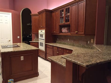 Besides, the dark and golden yellow parts of the granite create enough contrast if you choose the right type and color of the backsplash. Santa Cecilia Granite Countertops Installation Kitchen