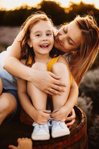 Premium Photo Portrait Of A Lovely Mother And Her Daughter While Girl Is Looking At Camera