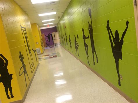 The Hallway Is Decorated With Silhouettes Of Dancers