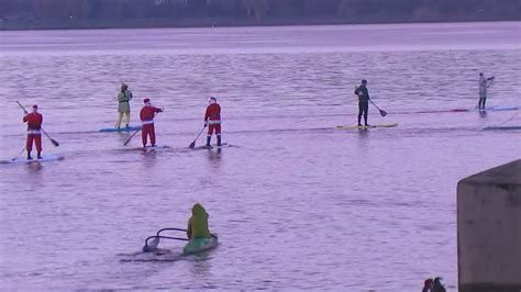 paddle boarding santas take to lake washington to raise money for people battling cancer