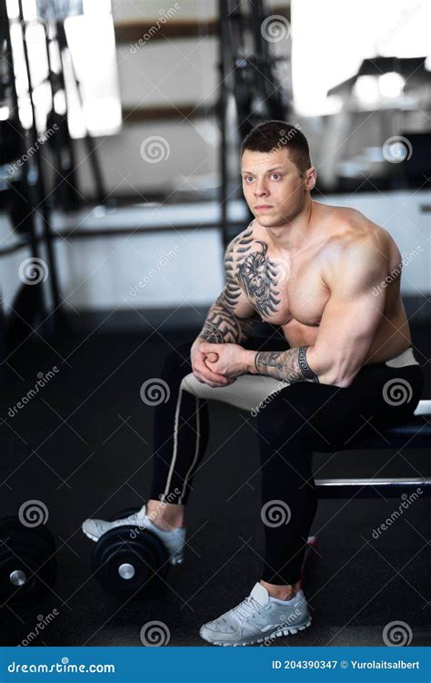 Young Bodybuilder Sitting On A Bench In The Gym Stock Image Image Of