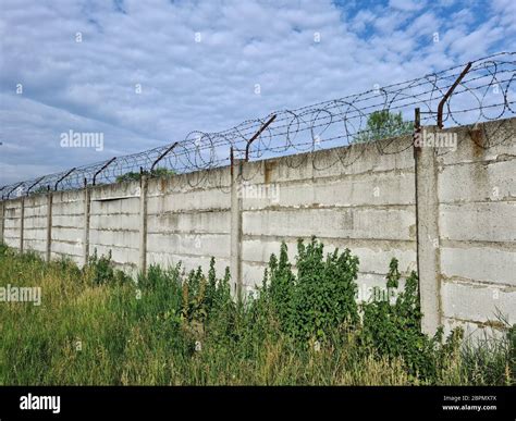 Barbed Wire On Concrete Fence Stock Photo Alamy