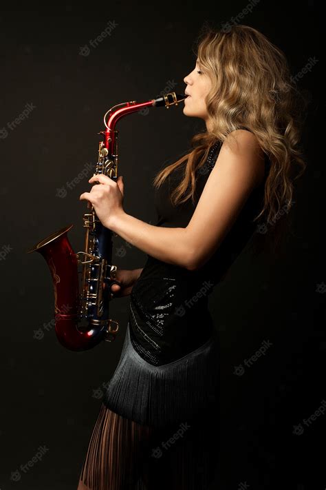 premium photo sexy attractive blonde women model with saxophone