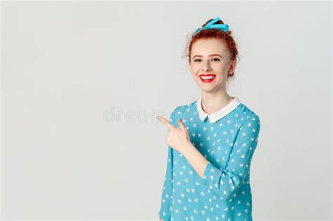 Smiling Ginger Woman Pointing Aside At Advertisement Area Copy Space For Promotion Stock Image