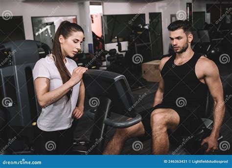 Attractive Trainer Instructing Handsome Sportsman Working Stock Image