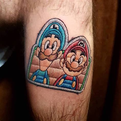 a man with a tattoo on his leg that has a mario and luigi in the shape of a heart