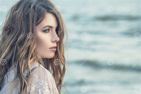 Beautiful Female Profile Perfect Woman With Curly Hair On Blue Ocean Background Stock Image