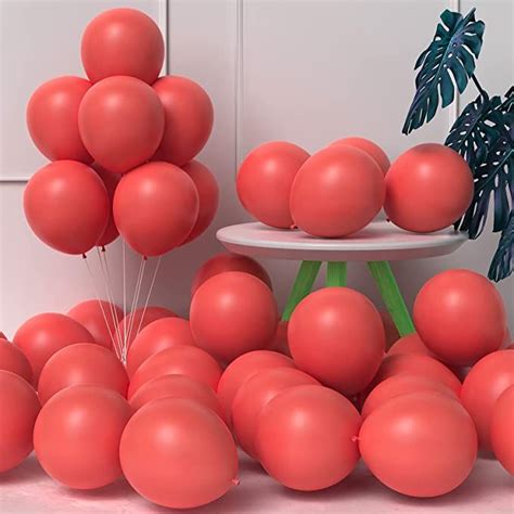 A Bunch Of Red Balloons Sitting On Top Of A Table