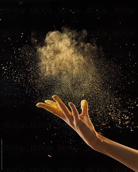 Beautiful Photo Of Female Hand Throwing Gold Dust On A Black