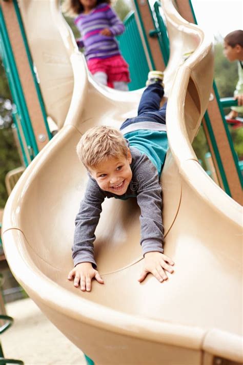 Young Boy Playing On Slide In Playground Stock Image Image Of