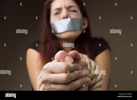 Brunette Hostage Gagged And Tied Hands On Blank Background Stock Photo Alamy