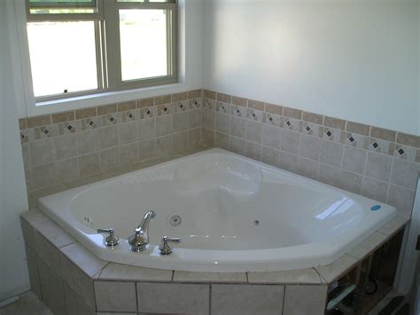A corner bathtub is shaped more like a triangle with the sides being each 60 long. » baths Kingston Builders