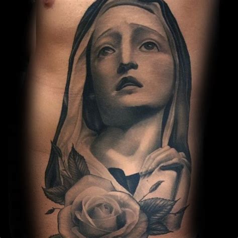 Suffering Virgin Mary Religious Gray Ink Realistic Tattoo On Man S Side With Rose Flower