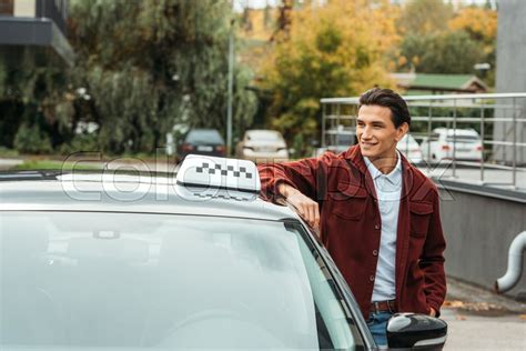 Smiling Taxi Driver Looking At Away Stock Image Colourbox