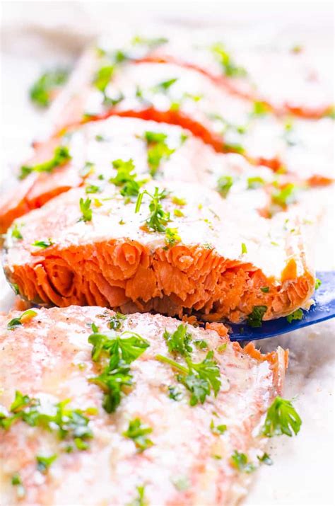 Read more side view of a fillet of baked salmon on a plate with salad in the background Baked Salmon in Foil - iFOODreal