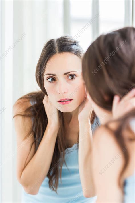 Woman Checking Her Face In The Mirror Stock Image C0352100