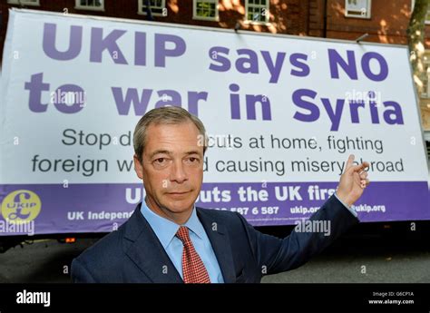 Nigel Farage The Leader Of Ukip Pointing At A Poster On A Van That