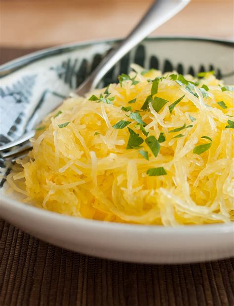 Once your squash is cut, take a metal spoon and scrape out the seeds in the center. How To Cook Spaghetti Squash in the Oven | Kitchn