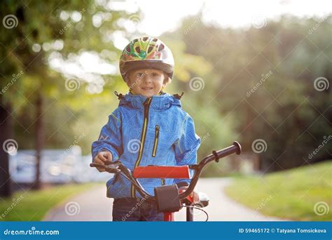 Cute Little Boy Toddler Child Riding Bike In A Helmet Stock Photo