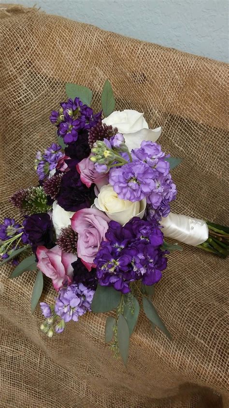 This round bouquet uses a 100. Bride's bouquet of white and purple roses, lavender and ...