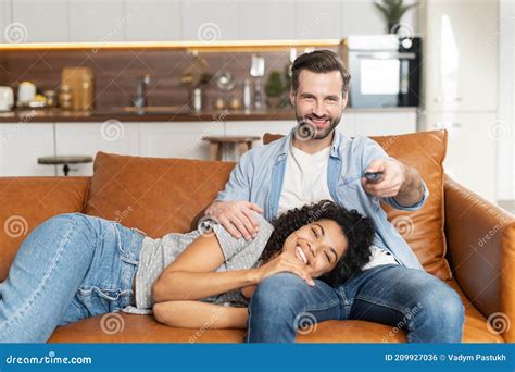 An Interracial Couple Chilling On The Couch Stock Photo Image Of