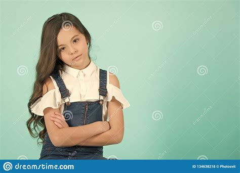 Girl With Serious Face Pose With Folded Hands Stock Photo