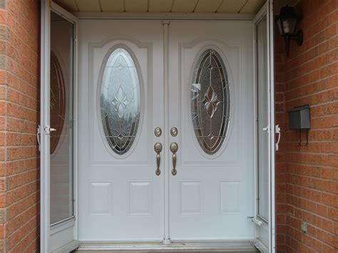An Elegant Set Of White Double Entry Doors With Custom Oval Door Lites