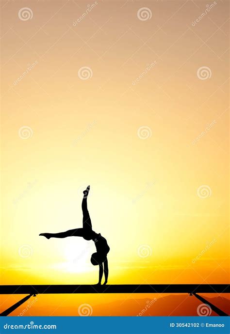 Back Handspring Of Female Gymnast In Sunset Sky Stock Image