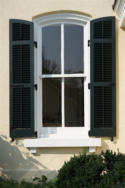 An Open Window With Black Shutters On The Outside