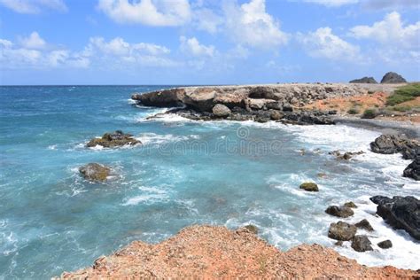 Tropical Waters Off The Shore Of Aruba`s Black Stone Beach Stock Photo