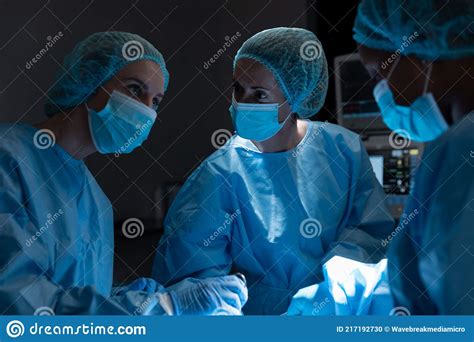 Diverse Group Of Male And Female Surgeons In Operating Theatre Wearing
