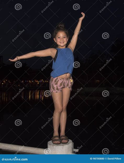 Nine Year Old Girl Singing With Microphone Royalty Free Stock Photo