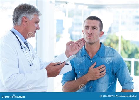 Doctor Examining His Patients Neck Stock Image Image Of Clinic