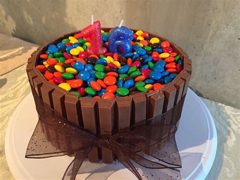 A Birthday Cake With Chocolate And Candy Toppings