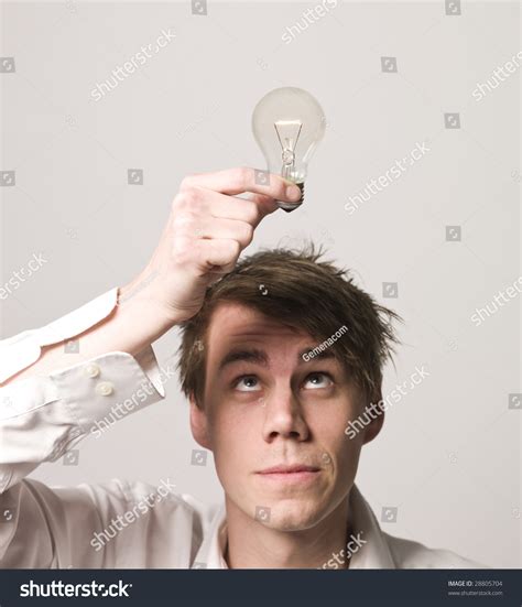Man Holding Electric Light Bulb Over His Head Stock Photo 28805704