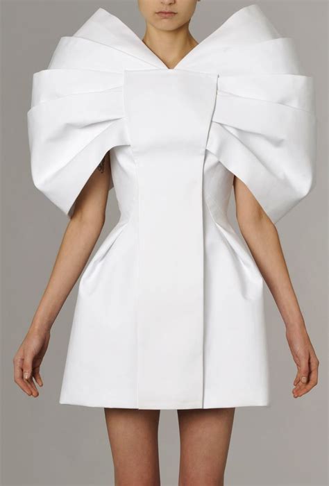 sculptural fashion white dress with three dimensional structured design clean lines symmetry