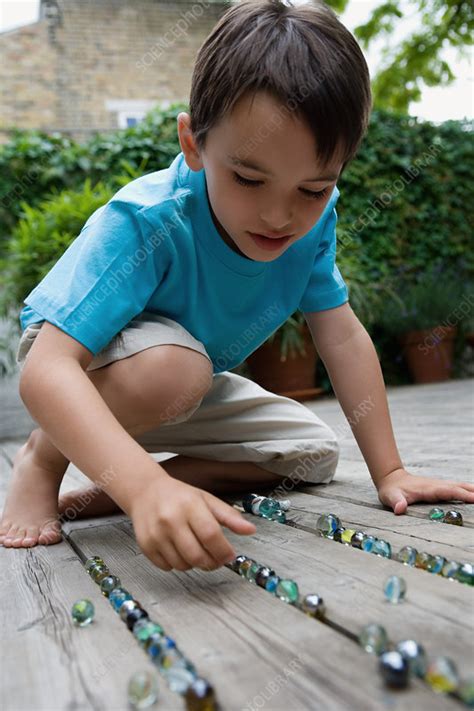Portrait Of A Boy Playing Marbles Stock Image F0033061 Science