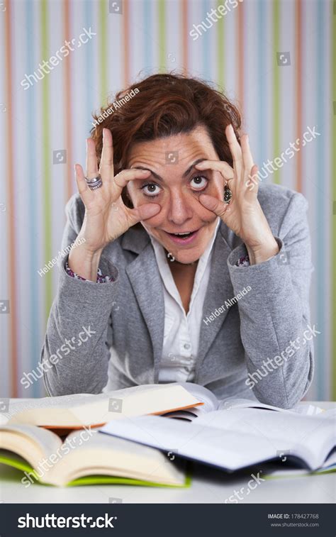 Businesswoman Overloaded With Work Holding Her Eyes Open Stock Photo