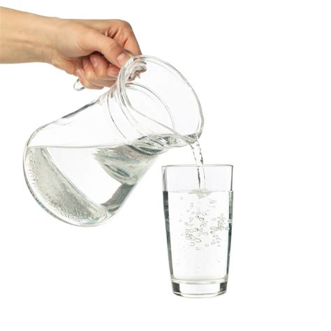 Premium Photo Pouring Purified Fresh Water From The Jug In Glass