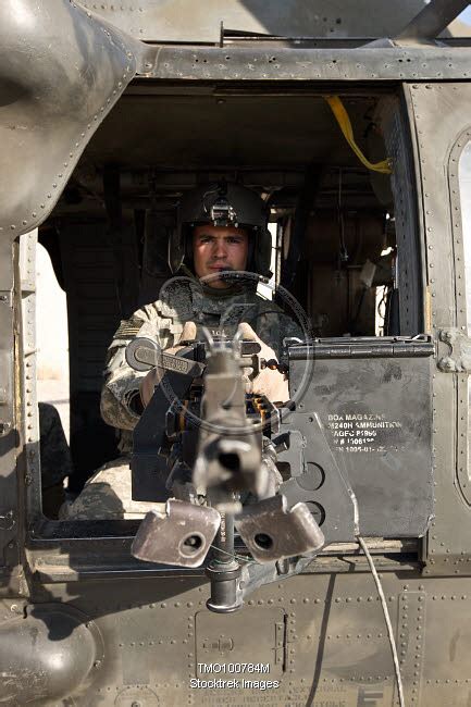 A Uh 60 Black Hawk Door Gunner Manning A M240b Machine Gun Stocktrek