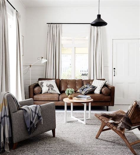 White walls contrast sharply against dark brown leather and paired with dark wood trim, they provide a very traditional look. Clean White Walls | Chic Ways To Style A Brown Sofa In Your Living Room | Living room grey ...