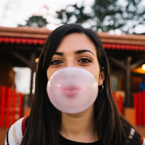 Premium Photo Girl Blowing Chewing Gum