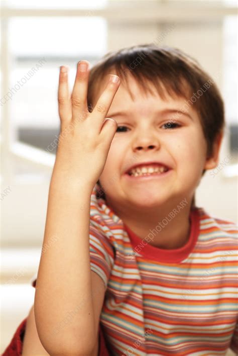Smiling Boy Holding Three Fingers Up Stock Image C0541360
