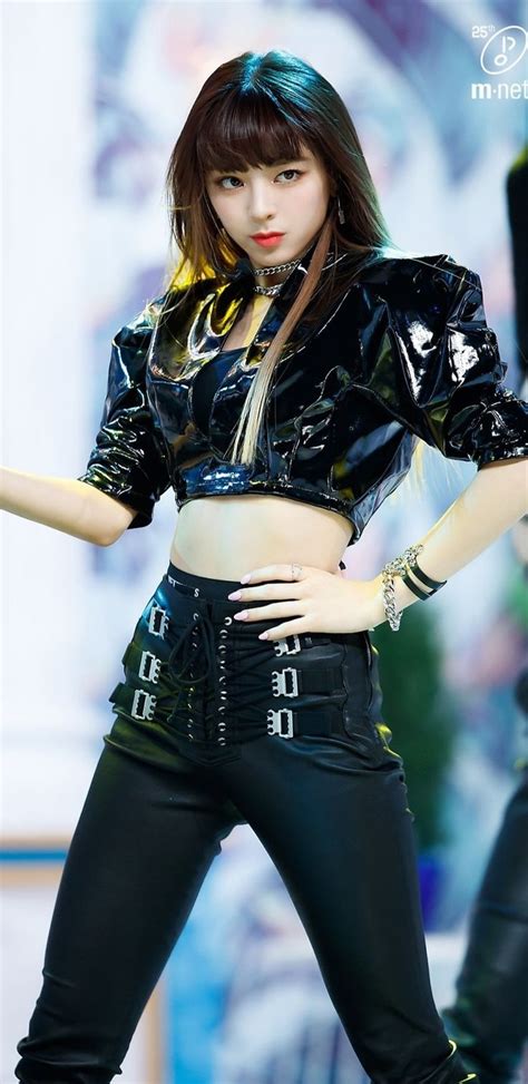 A Woman In Black Pants And Crop Top Posing With Her Hands On Her Hipss